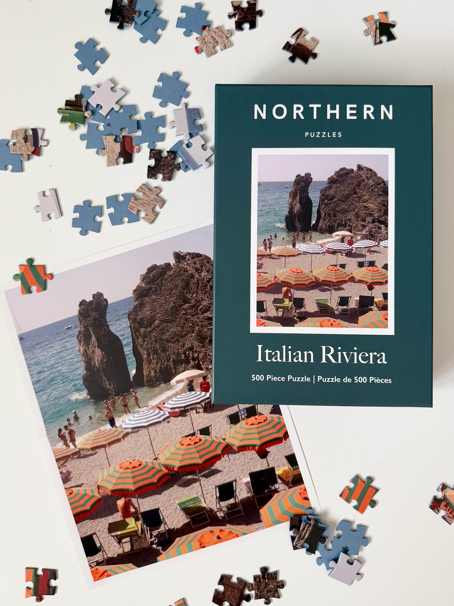 Jigsaw puzzle with puzzle pieces and a box labeled 'Northern Puzzles Italian Riviera' on a light background.